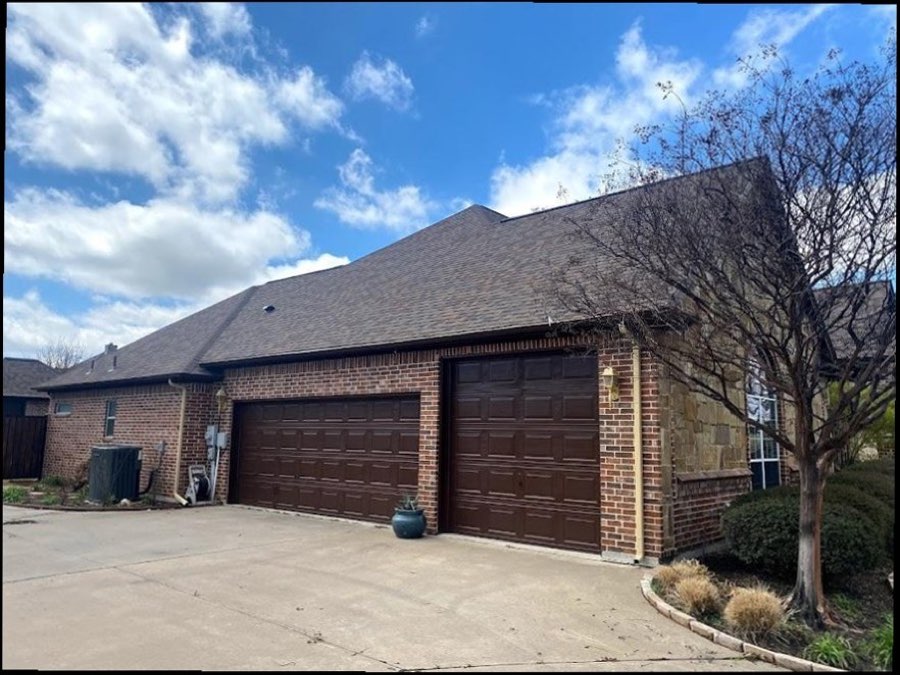 Home in the Tulsa area with a newly installed brown asphalt shingle roof